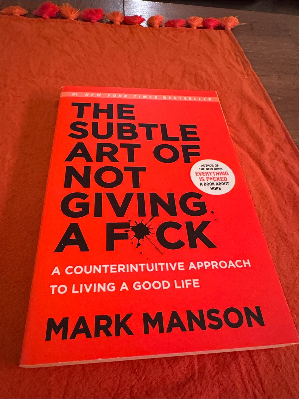 The Subtle Art of Not Giving a F*ck by Mark Manson - Bright Orange Paperback